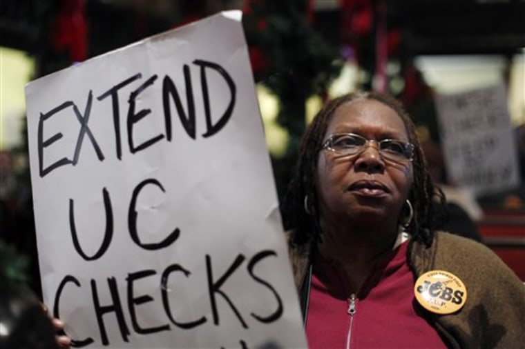 Yvette Ward who has been unemployed for two years displays a sign during a "Vigil for the Unemployed" at the Arch Street Methodist Church in Philadelphia. 